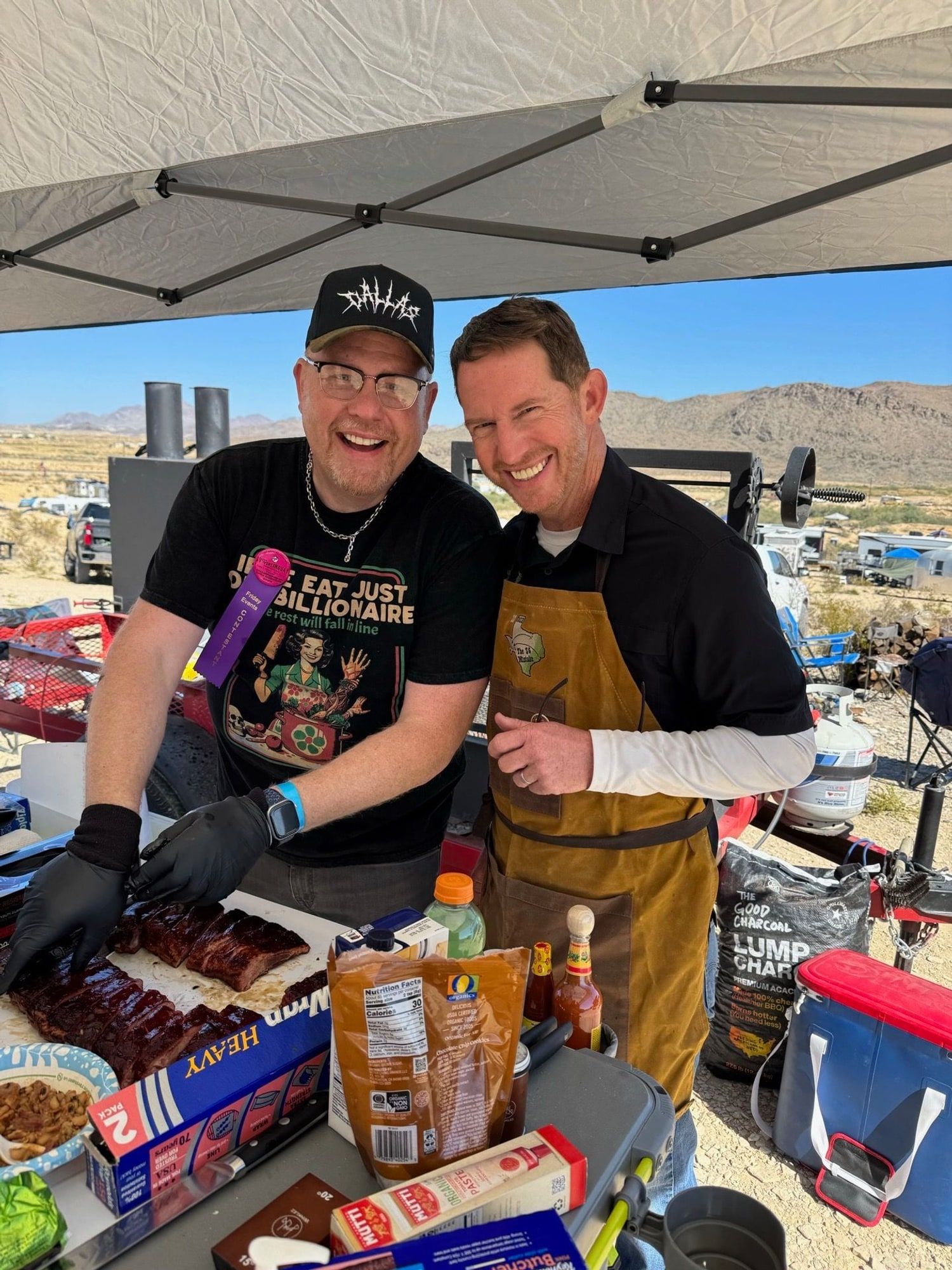 Danny Minton in an apron at a barbecue cook-off with a teammate