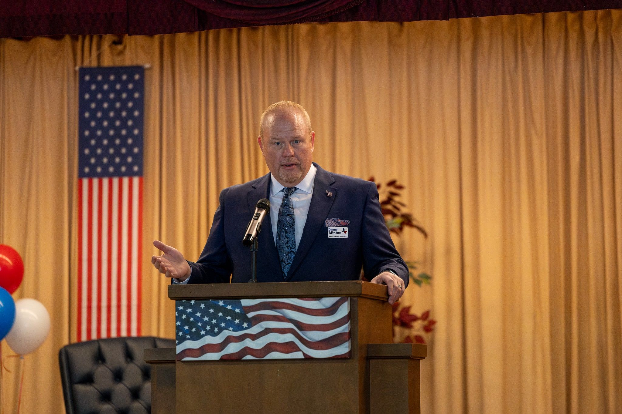 Danny Minton speaking at a podium